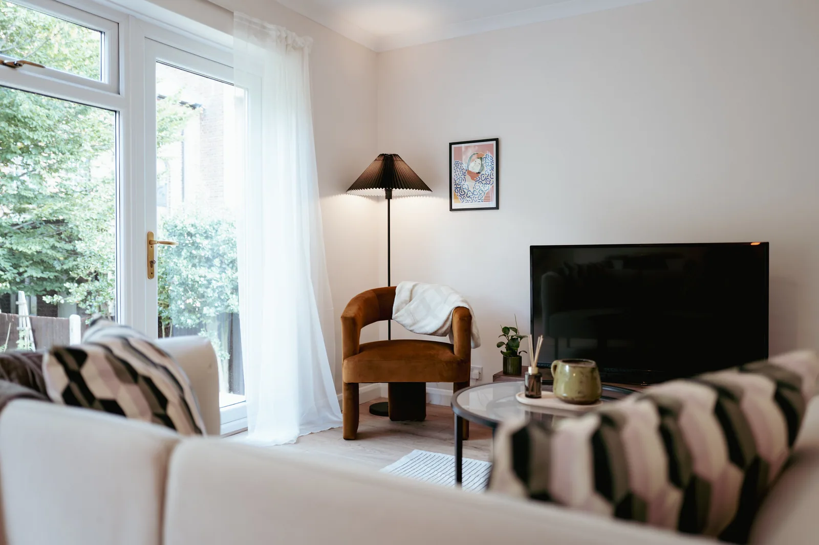 Naturally lit living room with a window, armchair and sofa